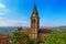 Old brick belfry under blue sky in Magliano Alfieri, Italy.