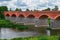 Old Brick bridge across the River Venta in the city of Kuldiga,