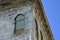 Old brick building with corbels and peeling paint