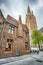 Old brick building, paved street and high church