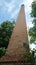 Old brick chimney of rice mill on river bank