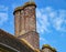 An old brick chimney stack atop an old English house