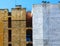 Old brick firewall next to new construction site. lightwell and chimneys.