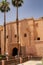 Old brick fortress facade building in a typical Arabian style in Marrakesh, Morocco