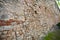 Old brick fortress wall of a small castle. Perspective view of the fence