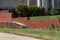 Old brick retaining wall in front of newer red brick retaining wall