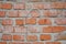 Old brick wall in a background image. Grungy Wide Brickwall. Grunge Red Stonewall Background. Shabby Building Facade