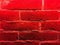 Old brick wall backlit by neon lamps