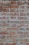 Old brick wall of a historic house. Sometimes worn brick, traces of corrosion, wind and water. Walls that have seen a lot