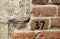 Old brick wall with the number thirty seven