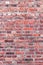 Old brick wall of red color, damaged masonry as abstract background composition