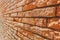 Old brick wall texture. Weathered wall surface. Grungy orange brickwall. Red stonewall background. Shabby building facade Italian