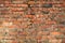 Old brick wall weathered and broken bricks, background