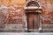 Old brick wall and wooden door at Venetian old street in Italy
