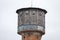 Old brick watertower with wood top, located in small countryside city centre