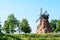 Old brick windmill on field on blue sky background