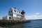 Old Brick and Wooden Lighthouse Sits at End of Breakwater in Mai