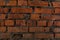 Old brickwork closeup. Red cracked bricks.