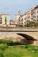 Old bridge in Girona, Spain, over a dry riverbed