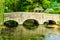 Old bridge over river Coln in village Bibury England