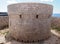 Old british fort of torre des castellar in ciutadella menorca with surrounding stone wall