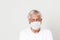 Old British men at risk by coronavirus. Old grey hair guy wearing a face mask for protection against coronavirus. Half body view o