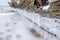 Old broken boat wreck and rocky beach in wintertime. Frozen sea, evening light and icy weather on shore like fairy tale country