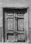 Old broken bolted shut door in an abandoned house