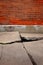 Old Broken Cement Cracked Sidewalk Brick Wall