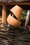 Old broken clay pot close up at wattle fence. Rural scene.