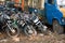 Old broken motorbikes and car in junkyard. India