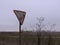 Old broken rusty road sign give salvage way in abandoned wasteland near airport