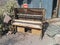 Old, broken Straube piano in front of desert shack