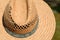 An old broken straw hat from the front and as a close-up, outdoors