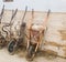 Old and broken wheelbarrows placed against the wall in a row outside