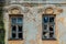 Old broken windows of abandoned mansion