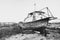 Old broken wooden ship on the shore. Black and white photo. Dramatic view