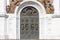 Old bronze door in the temple. The high gates of the temple, the arch on top of the bronze figures of angels.