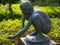 Old bronze statue of young crouching child, Tokyo Japan.