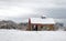 old brown barn and evergreen trees covered in freshly fallen Winter white snow