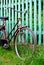 Old brown bike stands on a rural road