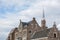 Old brown buildings under the blue sky with clouds