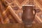 Old brown clay ceramic pottery retro handmade vase on the wooden table