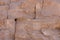 Old brown stone wall background, rough block texture.