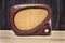 Old brown vintage bakelite Tesla radio on wooden background