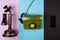 Old brown vintage telephone along with a wired green telephone and mobile phone on various color backgrounds. The concept of