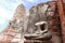 Old Buddha statue without head in the midst of ruins of the Chaiwatthanaram Temple Ayutthaya, Thailand