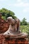 Old Buddha statue without head in the midst of ruins of the Chaiwatthanaram Temple Ayutthaya, Thailand