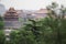 Old Buddhism Temple with Green Trees on Foreground. Red Asian Pagoda Towers. Ancient Architecture Asian Temples