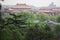 Old Buddhism Temple with Green Trees on Foreground. Red Asian Pagoda Towers. Ancient Architecture Asian Temples